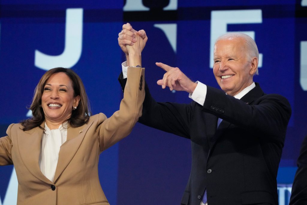 President Joe Biden speaks and Vice President Kamala Harris during the first day of the Democratic National Convention at the